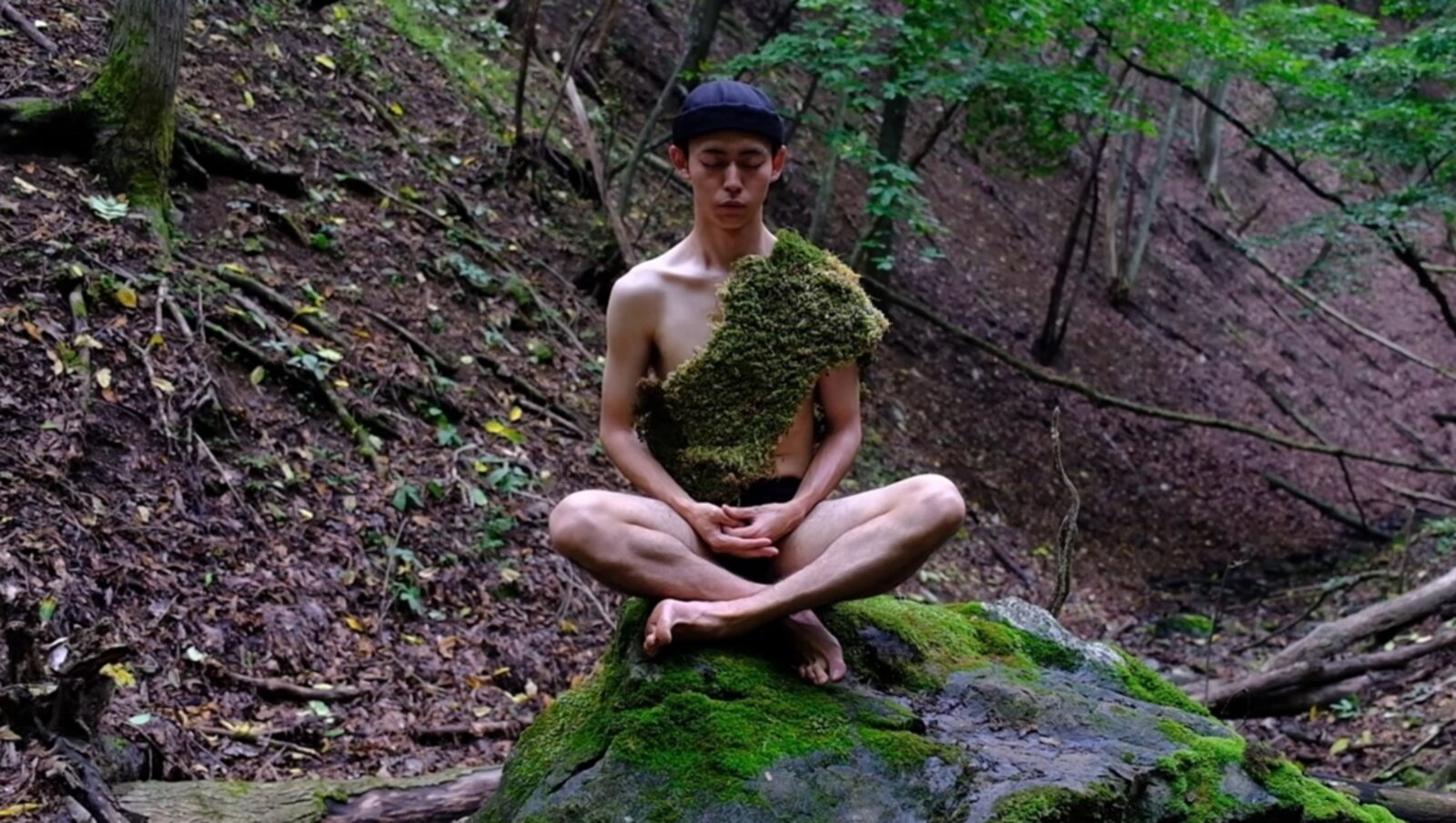 Wearing the living moss cloth in zazen on a rock in the mountains